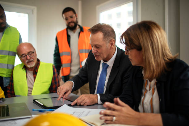 Project team reviewing renovation plans and specifications on site